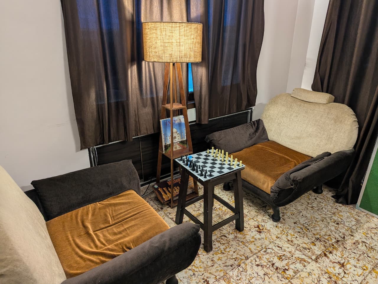 Quiet reading nook and chess corner with armchairs and books